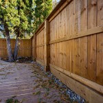 Wood fence with cladding on posts